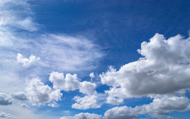 Magnificent cumulus clouds high in blue sky