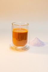 refreshing glass of Thai iced milk tea, served in a clear glass cup. The rich, vibrant orange color of the tea contrasts beautifully with the creamy milk at the bottom. A perfect blend