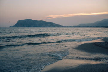 Beautiful sundawn scene on Alanya beach with view to famous Alanya island, in Turkey