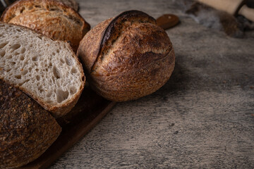 Golden-Crusted Artisan Sourdough Bread on a Rustic Wooden Table.