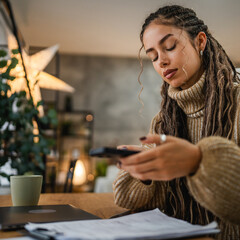 adult woman have contactless payment on mobile phone at home