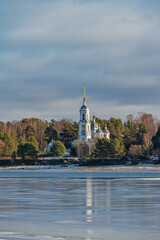 Fototapeta premium Winter Landscape with river and Temple on the far riverbank.