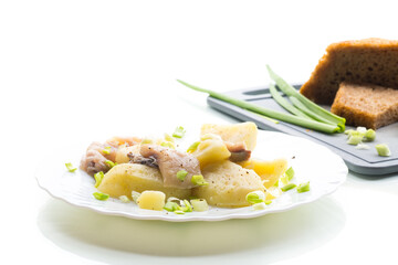 Homemade potatoes with aromatic fish, isolated on white background