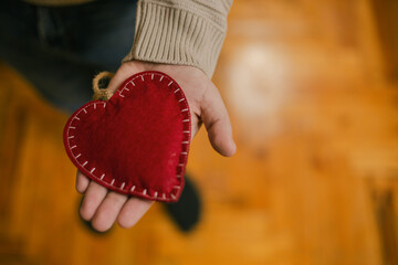 Man holds a heart present in his hands. Valentine's Day