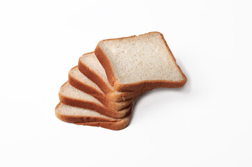 A stack of bread slices on a white background. The bread slices are all the same size and stacked on top of each other. Ecologically clean product.