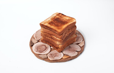 A stack of bread slices on a white background. The bread slices are all the same size and stacked on top of each other. Ecologically clean product.