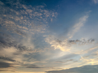 Cloud formations across the sky create a dramatic sunset atmosphere at dusk