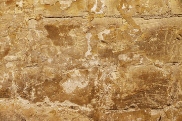 The surface of an old stone wall in the alleyways of Malta's historic towns.