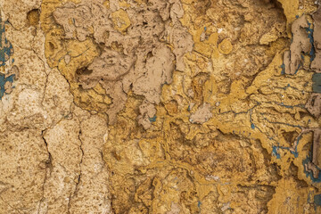 The texture of an ancient stone wall in the narrow streets of Malta's historic quarters.