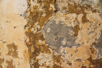 A close-up of a weathered stone wall in Malta's timeless alleys.