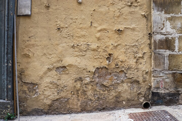 An ancient stone wall standing quietly in Malta's historic walkways.