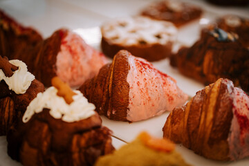 Freshly baked croissants await coffee lovers in a bustling café setting during the morning rush