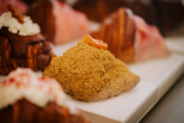 Freshly baked croissants on display in a cozy coffee shop inviting customers to enjoy delicious pastries