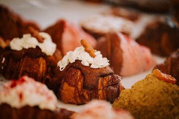 Freshly baked croissants displayed on the counter of a cozy coffee shop ready for customers to enjoy
