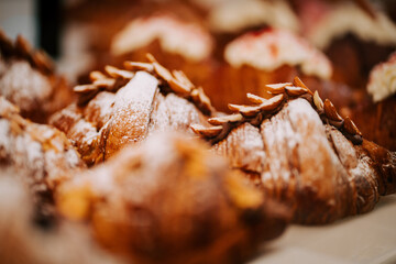 Freshly baked croissants cooling on the counter in a cozy coffee shop