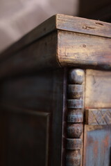 Close-up shot of wooden chair frame with intricate details.