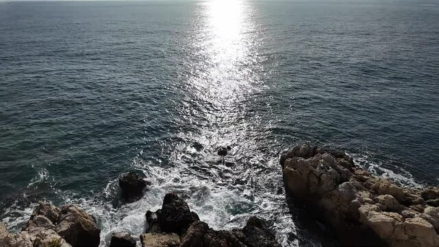 The coast of the French Riviera at sunset. Blue sea, rocks.