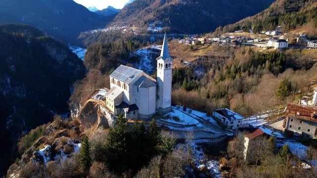 Winter Aerial View of Valle di Cadore Village near Cortina d'Ampezzo: Historic Church and Snowy Dolomites Peaks, 4K Drone Footage of 2026 Winter Olympic Host Region, Belluno Veneto, Northern Italy