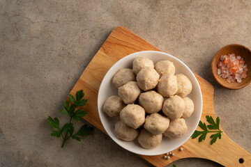 Uncooked Thai Pork meatballs on white plate.Top view with copy space.