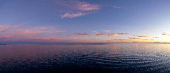 Soft super wide panorama of crack of dawn just before sunrise at the San Pedro de Alcantar beach in...