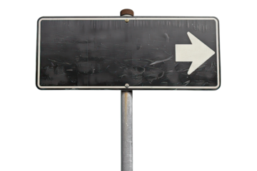 A worn road sign with an arrow pointing right stands alone on a rural road, beckoning travelers to embark on new journeys and experiences in the countryside