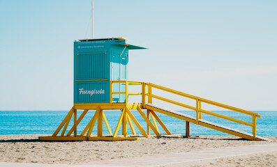 A lifeguard tower constructed on a beach, complete with a ramp that provides easy access leading up to it for safety purposes