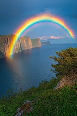 Vibrant rainbow arcs over cliffs and ocean at dawn in a breathtaking coastal landscape