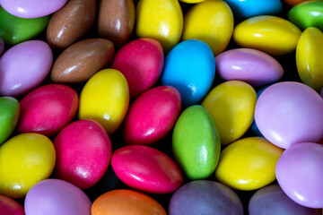 Colorful candy eggs displayed in a bright assortment on a surface
