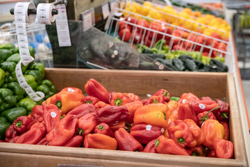 sweet red and hot green peppers sold at the farm store. Bell peppers in crates.