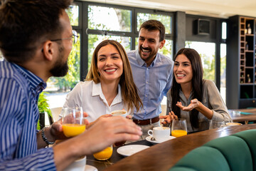 Group of friends met at the restaurant. They hang out, drink coffee and laugh.