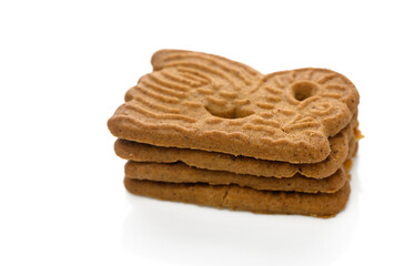 Gingerbread cookies stacked artfully on a white background capturing their intricate designs
