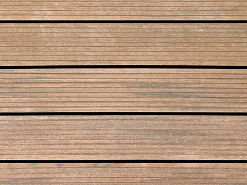 Close up of natural wood decking with grouts, suitable for outdoor pool deck. Wooden deck seamless texture, natural wood, PVC wood texture. No people.