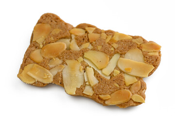 Delicious almond-studded cookie shaped like a playful animal sitting on a white surface