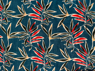Fabric in random leaves and flowers pattern, red and yellow leaves with blue background. Printed...