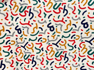 Obraz premium Close up pattern of confetti printed on a fabric or wallpaper. Colorful abstract confetti paper shapes scattered randomly on a white background. Suitable for kids. Seamless background texture.