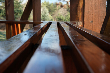 Reflections on shiny wood beams in a calm outdoor space