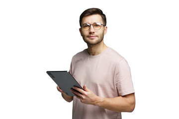 Young man with glasses holding a tablet and smiling, indoors in a bright setting