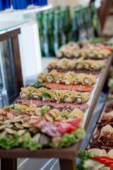 Wedding table with snacks, ham, crayfish and salads