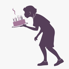 Obraz premium Silhouette of a person blowing out birthday candles