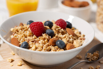 breakfast with homemade granola with nuts and berries, closeup