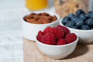 fresh berries, nuts, muesli and orange juice