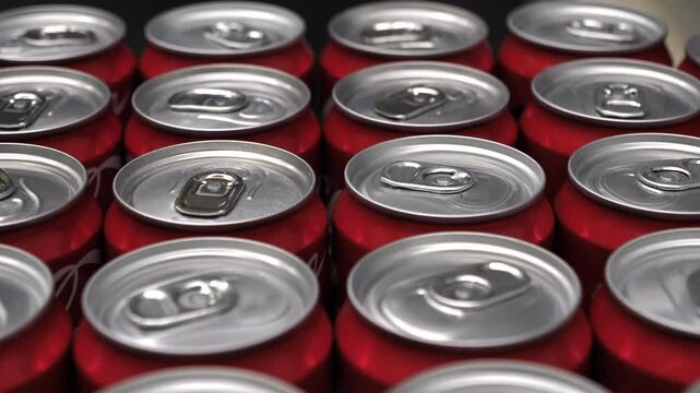  Aluminum beverage cans at a manufacturing facility. The variety of metal cans highlights the intricate details of the manufacturing process. Warehouse with carbonated beverage cans