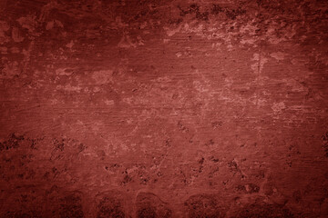 Red texture of a concrete wall with natural relief 