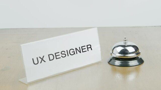 UX Designer Office or Room with Hand Ringing The Bell on Desk or Table Multiple Times