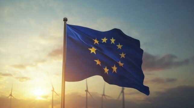 European Union flag waving against a vibrant sunset with wind turbines in the background