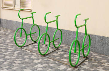 Bicycle parking place against a yellow wall. Original bicycle parking design