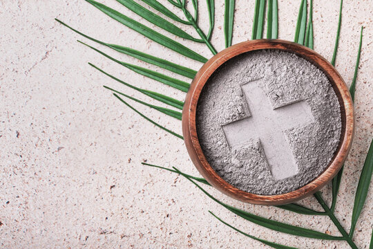 Ash wednesday background with cross in ashes and palm leaf