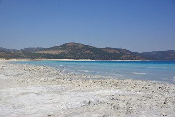 Serene Lake Landscape with white sand and a mountain copy space  © Irina