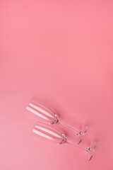 Concept Valentine's day, wedding, date, birthday. Empty champagne glasses on pink background with copy space.