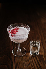 cocktail with shot glass on wooden table top view